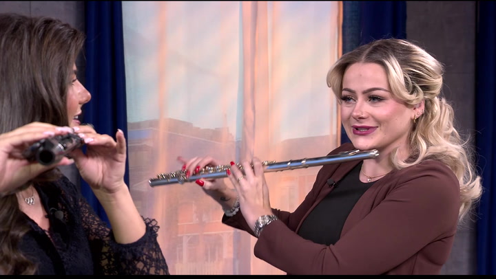 Mina teaches Raegan how to play the flute